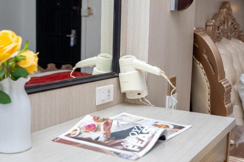 a table with a mirror and a magazine on it at Lucky city hotel in Vientiane