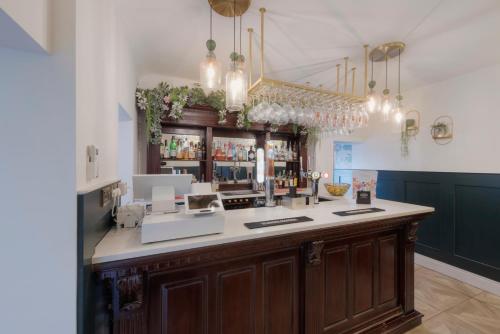 a bar with a counter in a room at Florence Suite Boutique Hotel and Restaurant in Portsmouth