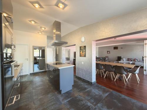 a kitchen and living room with a table and chairs at Cityscape Loft Hannover - 216qm 15 Personen in Hannover
