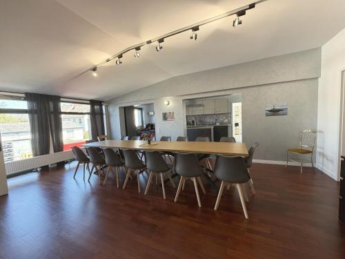 a dining room with a large wooden table and chairs at Cityscape Loft Hannover - 216qm 15 Personen in Hannover
