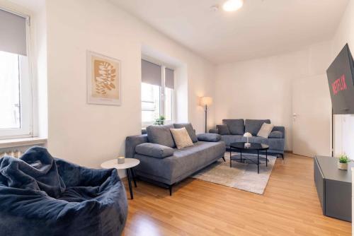 a living room with two couches and a tv at Laacher-Loft Ferienwohnung in Mendig