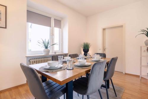 a dining room with a wooden table and chairs at Laacher-Loft Ferienwohnung in Mendig