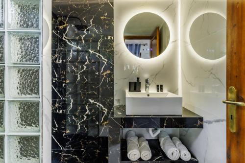 a bathroom with a sink and a mirror at Artemis Bungalows in Stafylos