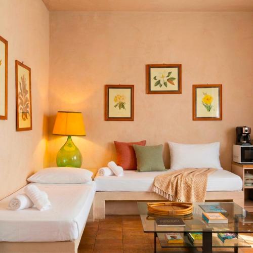 a living room with two beds and a table at Baia delle Rocce Verdi Resort in Naples