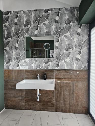 a bathroom with a sink and a mirror at Luxus-Penthouse mit einzigartigem Schlossblick in Bad Berleburg