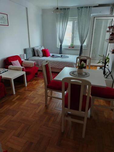 a living room with a couch and a table at Apartman Mira in Požarevac