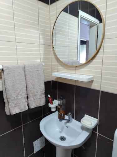 a bathroom with a sink and a mirror at Apartman Mira in Požarevac