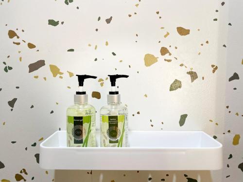 two bottles of soap on a sink in a bathroom at 5 homestay central in Vung Tau