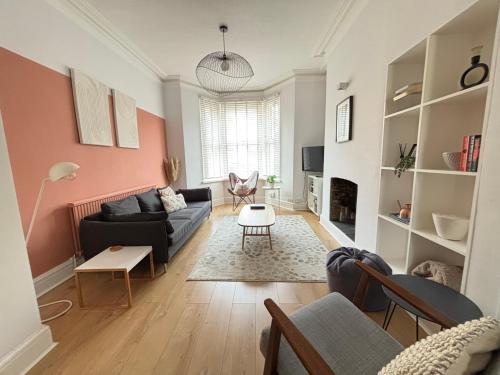 a living room with a couch and a table at TAFFS MEAD HOUSE Central City Location, nr Stadium, Family Friendly! in Cardiff