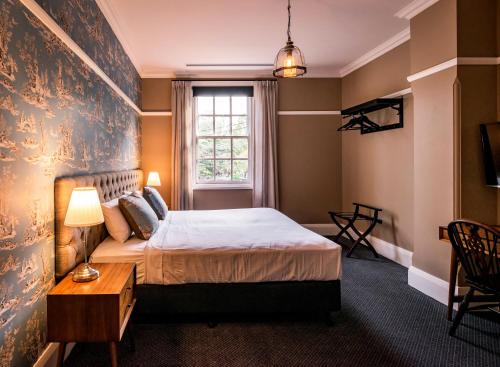 a bedroom with a bed and a window at The North Sydney Hotel in Sydney