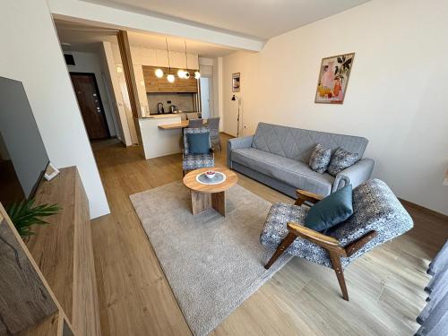a living room with a couch and a table at Apartman Jančić in Loznica