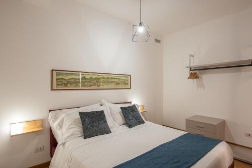 a bedroom with a white bed with two pillows at U Genova in Genoa