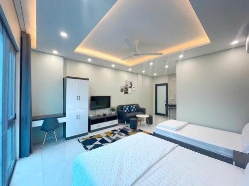 a bedroom with a bed and a desk and a tv at CH home apartment in Hanoi