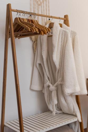 a wooden rack with white towels on it at Peaceful Retreat near Sesimbra and Meco Beach - MADA HOUSE's II in Sesimbra