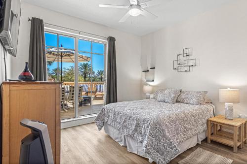 a bedroom with a bed and a balcony at Coastal Serenity Spacious 3Br Condo In Minorca in New Smyrna Beach