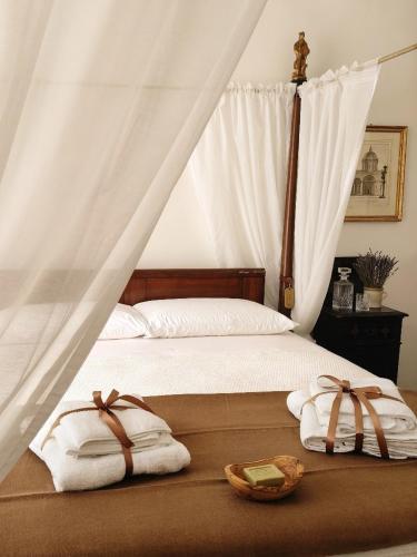 a bedroom with a bed with two towels on it at La Dama Stanca in Narni