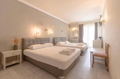 a bedroom with two beds and a window at Mironi & Victoria in Limenas