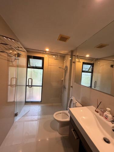 a bathroom with a toilet and a sink and a shower at The Title Rawai in Ban Saiyuan (1)