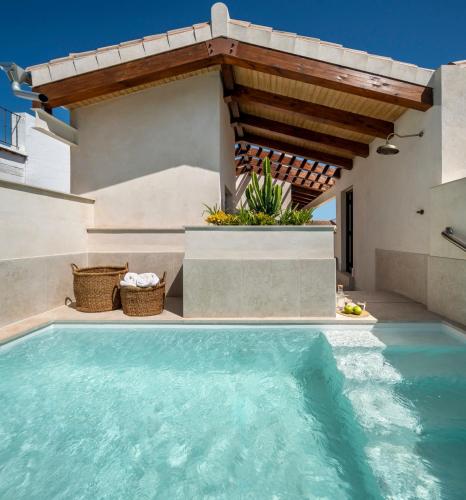 a swimming pool in the backyard of a house at Magno Collection Palacio de Becas in Seville