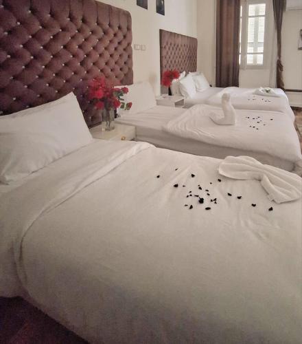 a bedroom with two beds with flowers on them at Hotel velvet One in Cairo