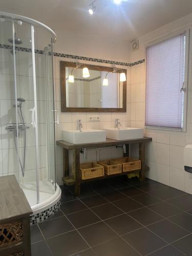 a bathroom with two sinks and a shower at Haus Janne in Zell an der Mosel