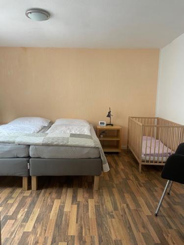 a bedroom with a bed and a crib at Haus Janne in Zell an der Mosel