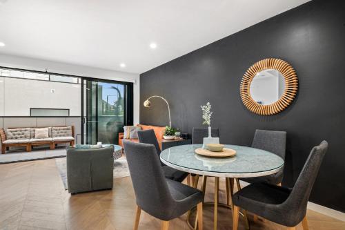 a dining room with a table and chairs at Chic Home with BBQ & Outdoor Dining in Carnegie