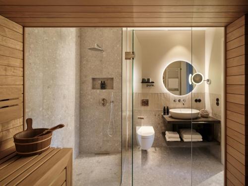 a bathroom with a shower and a toilet and a sink at THE SHORELINE Sellin in Ostseebad Sellin