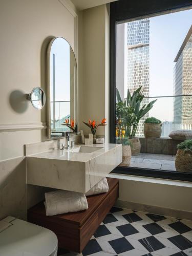 a bathroom with a large sink and a large window at Taj Hessischer Hof Frankfurt in Frankfurt