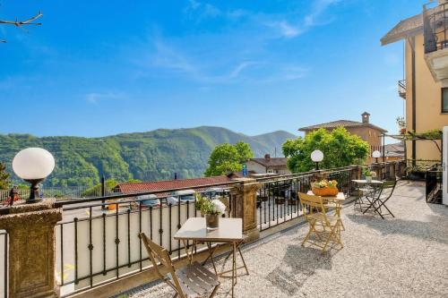 a balcony with tables and chairs and a view of mountains at Rooms in Villa Agra in Agra
