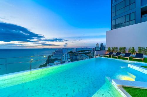 a swimming pool on the roof of a building with a view at Andromeda Condominium Pattaya in Pattaya South
