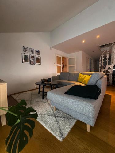 a living room with a couch and a table at Exclusive Northernlight villa at Sørtromsøya in Tromsø