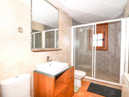 a bathroom with a sink and a toilet and a shower at Casa Socias in Comarruga