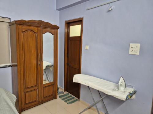 a room with a table and a medicine cabinet at Bliss Inn in Benaulim
