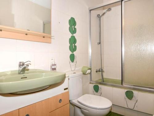 a bathroom with a white toilet and a sink at Villa Maite in Roda de Bará
