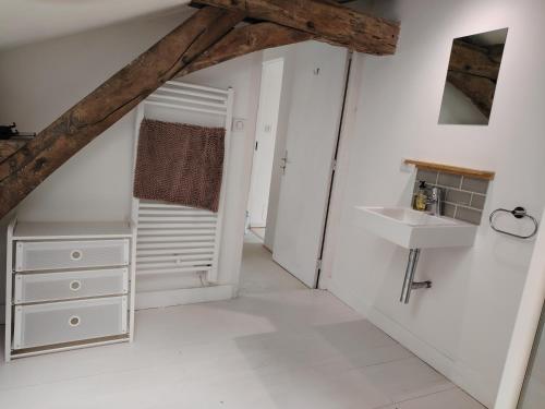 a bathroom with white walls and a sink at Nouveau - Maison de charme - Centre de Bourdeilles in Brantome en Perigord