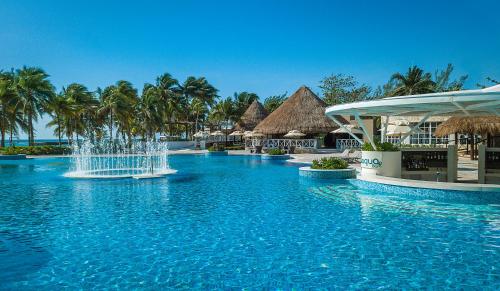 a swimming pool at a resort with a fountain at Catalonia Royal Tulum Beach & Spa Resort Adults Only - All Inclusive in Xpu Ha