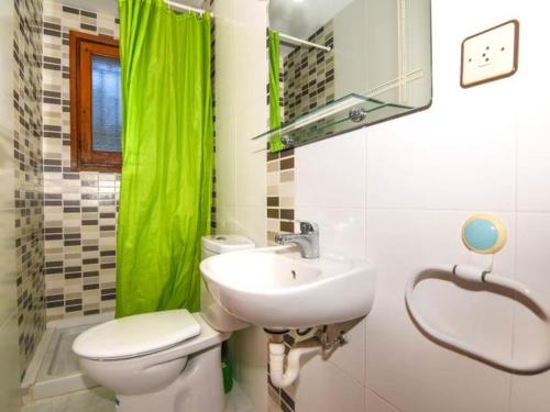 a bathroom with a white toilet and a sink at Enric Borras in Roda de Bará
