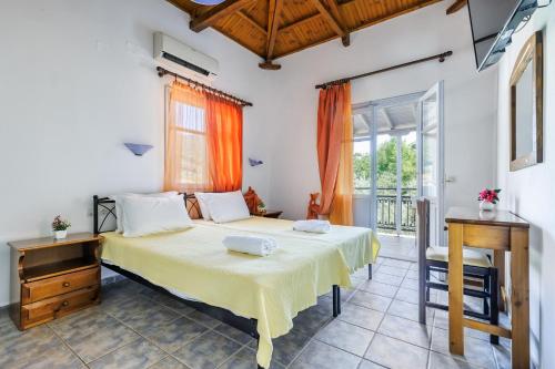 a bedroom with a large bed in a room at Artemis Bungalows in Stafylos