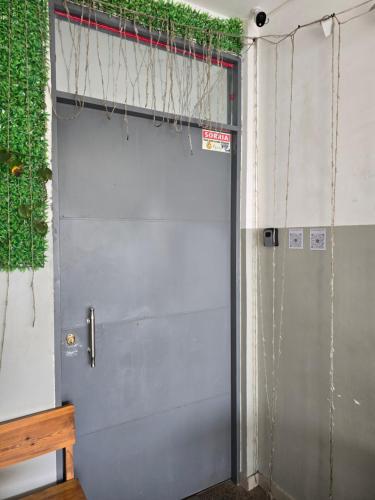 a metal garage door with vines growing on it at My Flat 2 in Praia