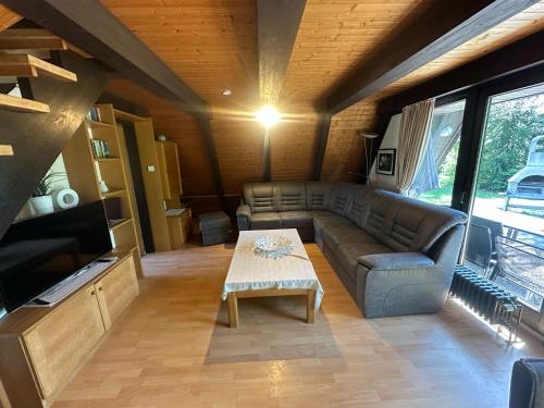 a living room with a couch and a table at Ferienhaus Winnetou 114 in Waldbrunn