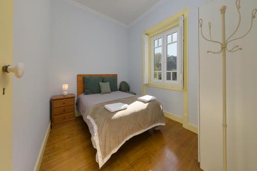 a bedroom with a bed and a window at Casa Mariana 1 - Sintra, Pena Palace & Castle Views, Terrace Apartment in Sintra