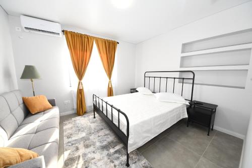 a bedroom with a bed and a couch at Stay Inn in Galaţi