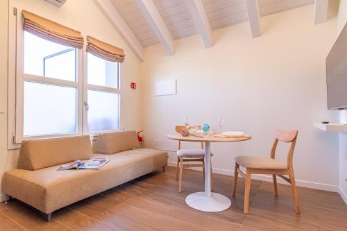 a living room with a couch and a table at Nobel Flower Apartments in Lissone