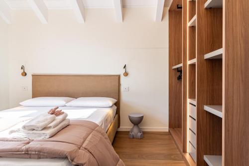 a bedroom with a bed with white sheets at Nobel Flower Apartments in Lissone