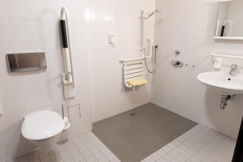a bathroom with a toilet and a sink at Hotel Marthahaus in Halle an der Saale