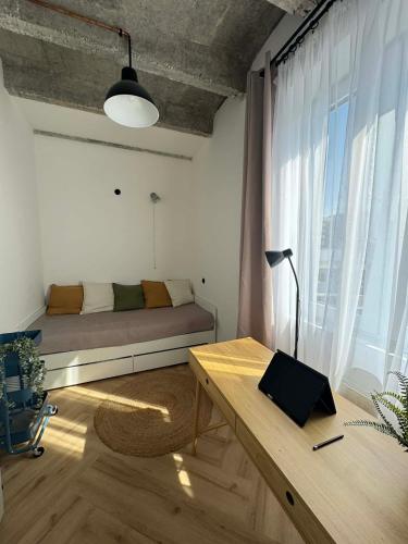 a living room with a couch and a window at Old Town, The Reward apartment with terrace with a view in Staré Mesto