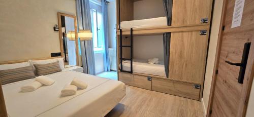 a bedroom with a bed with two towels on it at Das Carretas in Madrid