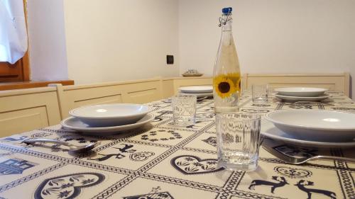 a table with a table cloth with a bottle on it at Casa Rossi in Le Grazie