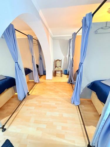 a room with two beds and a chair at Hostel Chisinau Centru in Chişinău